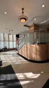a large lobby with a glass railing in a building at Crescent Hotel in Long Island City