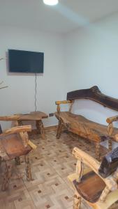 a room with wooden furniture and a flat screen tv at APARTAMENTO TURISTICO SALENTO QUINDIO R. in Salento