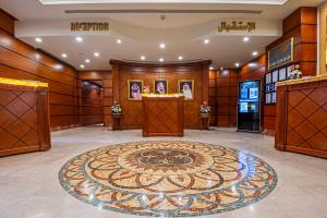 a lobby with a large rug on the floor at Dar Al Taqwa Hotel in Al Madinah