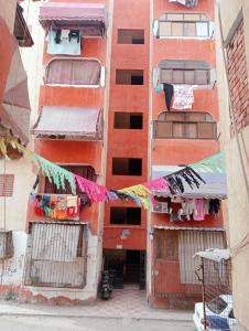 an overhead view of an alley with clothes hanging from buildings at شقة فندقية في بورسعيد Hotel apartment in Port Said in Port Said