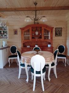 a dining room with a table and chairs at Agroturystyka Przy Siole Budy in Białowieża