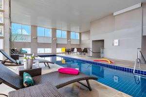 an indoor pool with chairs and a swimming pool at Get a Flat 1203 Bela Vista Excelente Localização SP in São Paulo