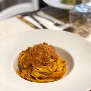 a bowl of pasta on a white plate at Hotel la locanda di montecatone in Imola