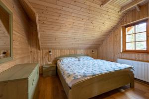 a bedroom with a bed in a wooden room at Apartments Brina in Bohinj +68 photos