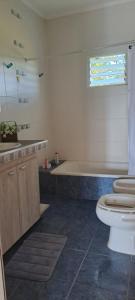 a bathroom with a tub and a toilet and a sink at Alojamiento Ibirá in San José +22 photos