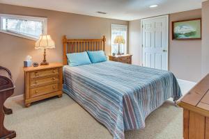 a bedroom with a bed with a blue comforter at Pet-Friendly Rutherfordton Home with Deck and Views! in Rutherfordton