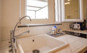 a white sink in a kitchen with a window at La terrazza di Maria in Procida