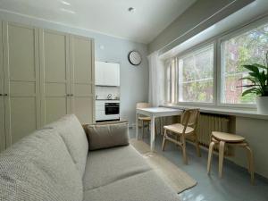 a living room with a couch and a table at Hogland Apartments - 1 in Kotka