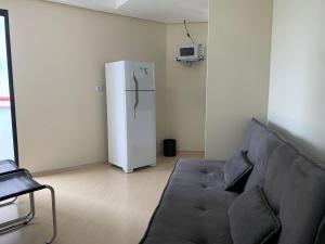 a living room with a couch and a refrigerator at Get a Flat 1205 Bienal - Ibirapuera in Sao Paulo