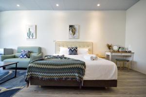 a hotel room with a bed and a couch at Full house in Taitung City