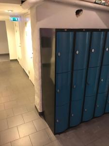 a row of blue lockers in a hallway at Hostel Dalagatan in Stockholm
