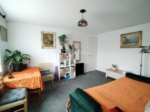 a bedroom with two beds and a table at Home Away Home near Heathrow Airport in Cowley