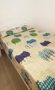 a table with a quilt with animals on it at Miras Guest House in Praia