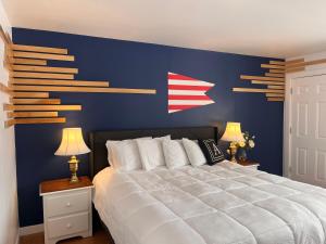 a bedroom with a large bed with a blue wall at Acadia Ocean View Hotel in Bar Harbor