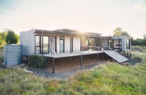 a modular house with a large deck in a field at The Herenberg Rosendal in Rosendal