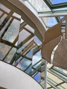 a glass ceiling with a chair in a building at Maison Sofia - MGallery in Sofia
