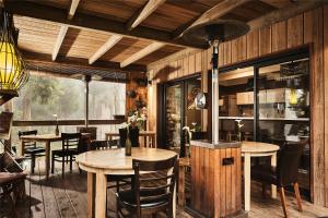 a dining room with wooden tables and chairs at KAZ INSOLITE in Saint-Louis