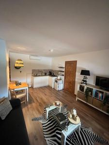 a living room with a zebra rug on a wooden floor at Villa Casa Rosa, El Torcal in Almogía