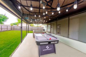 a patio with a pool table on a house at Delray Family House With Hot Tub in Tampa