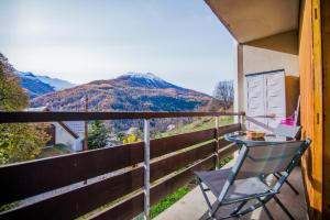 einen Stuhl auf einem Balkon mit Bergblick in der Unterkunft Les Tilleuls 24 - balcon vue montagne in Orcières