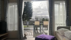 a living room with a view of a balcony at Pet Friendly 2-Bed Lodge near Preston & Blackpool in Preston