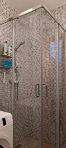 a shower with a glass door in a bathroom at Seaside apartment in Krk