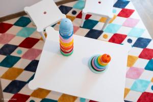 a table with a toy and two chairs on a colorful floor at Disney à 10 min: Maison paisible 8P, Wifi, Parking in Chessy +24 photos
