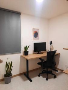an office with a desk with a computer on it at Cozy Apartment in Historic Prado with adjustable desk and 4K Monitor in Medellín