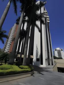 a building with palm trees in front of it at Get a Flat - 703 Luxo e Conforto - Ibirapuera in São Paulo