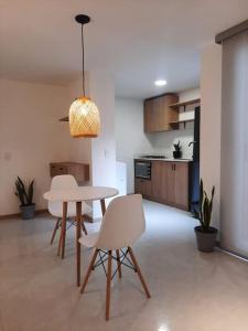 a kitchen and dining room with a table and chairs at Cozy Apartment in Historic Prado with adjustable desk and 4K Monitor in Medellín