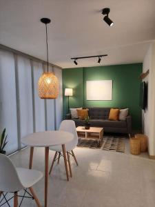 a living room with a couch and a table and chairs at Cozy Apartment in Historic Prado with adjustable desk and 4K Monitor in Medellín