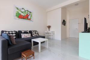 a living room with a couch and a table at Cozy 2BR Heart in Tel Aviv in Tel Aviv