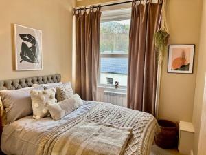 een slaapkamer met een bed voor een raam bij Bank House, Settle, Yorkshire Dales in Settle