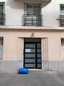 a blue bag sitting in front of a building at Lovely flat near the majestic Eiffel Tower in Paris
