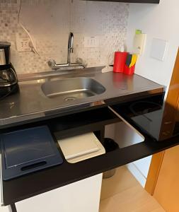 a kitchen with a sink and a counter top at Get a Flat 701 - Ibirapuera -Jardins in Sao Paulo