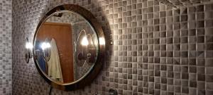 a bathroom with a mirror on a tiled wall at Seaside apartment in Krk