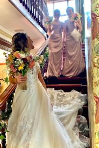 a bride walking down the stairs with her daughters at The Old Vicarage NI B&B in Ballywalter
