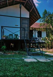a house with a staircase in the yard at Oryza wayanad in Kalpetta