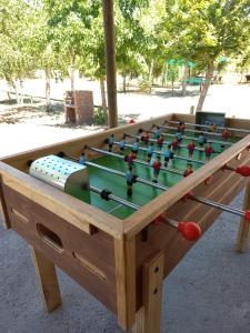 a wooden foosball table with balls on it at Cabaña con jacuzzi, 7 personas. in Quillón