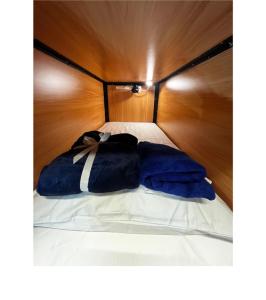 מיטה או מיטות בחדר ב-Capsuleaccom Hostel