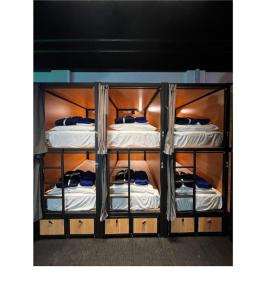 מיטה או מיטות בחדר ב-Capsuleaccom Hostel