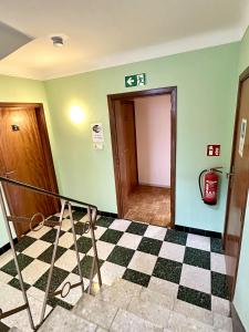 a room with a staircase and a door with a checkered floor at Maison entière/ Entire house with privat 3 Parking in Kayl