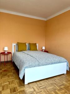 a bedroom with a large bed with two tables at Maison entière/ Entire house with privat 3 Parking in Kayl