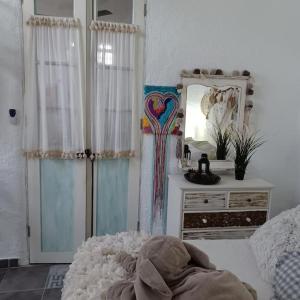 a bedroom with a bed and a mirror and a dresser at Apartamento Cabo Rubio in La Guancha