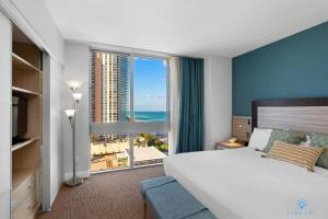 a bedroom with a large bed and a large window at Beachfront Resort POOL OCEAN VIEW BALCONY in Miami Beach +30 photos