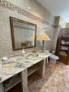 a bathroom with a sink and a mirror and a toilet at Villa Grao Castellon Ref 053 in Grao de Castellón