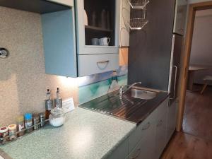 a kitchen with a sink and a counter top at Ferienwohnungen Ansbach - Ansbach Apartments - Your home away from home! in Ansbach
