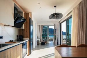 a kitchen with a view of a living room at RIRIKA Beach Living, New Feel-at-Home Luxury Suites in Plakias