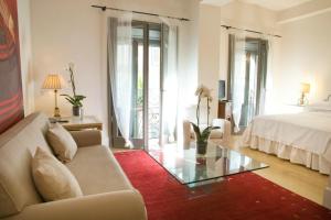 a living room with a couch and a glass table at Milano Suites in Milan