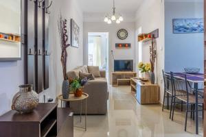 a living room with a couch and a table at Comfy Central Square Gem with Balcony in Kalamata